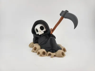 Grim Reaper Relaxing on Skulls – Tristo Mietitore sui Teschi