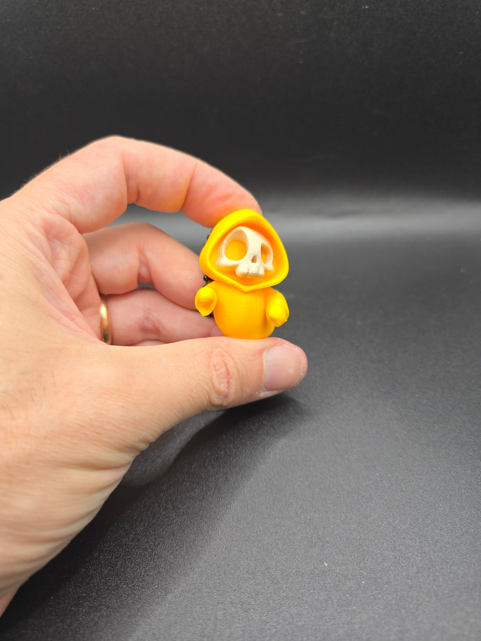 Portachiavi Halloween – Mini scheletro con cappuccio giallo