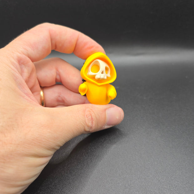 Portachiavi Halloween – Mini scheletro con cappuccio giallo